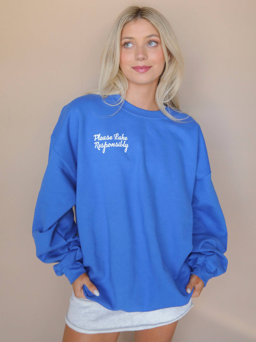 front view of Lake Responsibly' Sweatshirt in blue crewneck, perfect for stylish lake days. Ideal gift when paired with a drink sleeve. Emphasizes responsible enjoyment of lake activities.