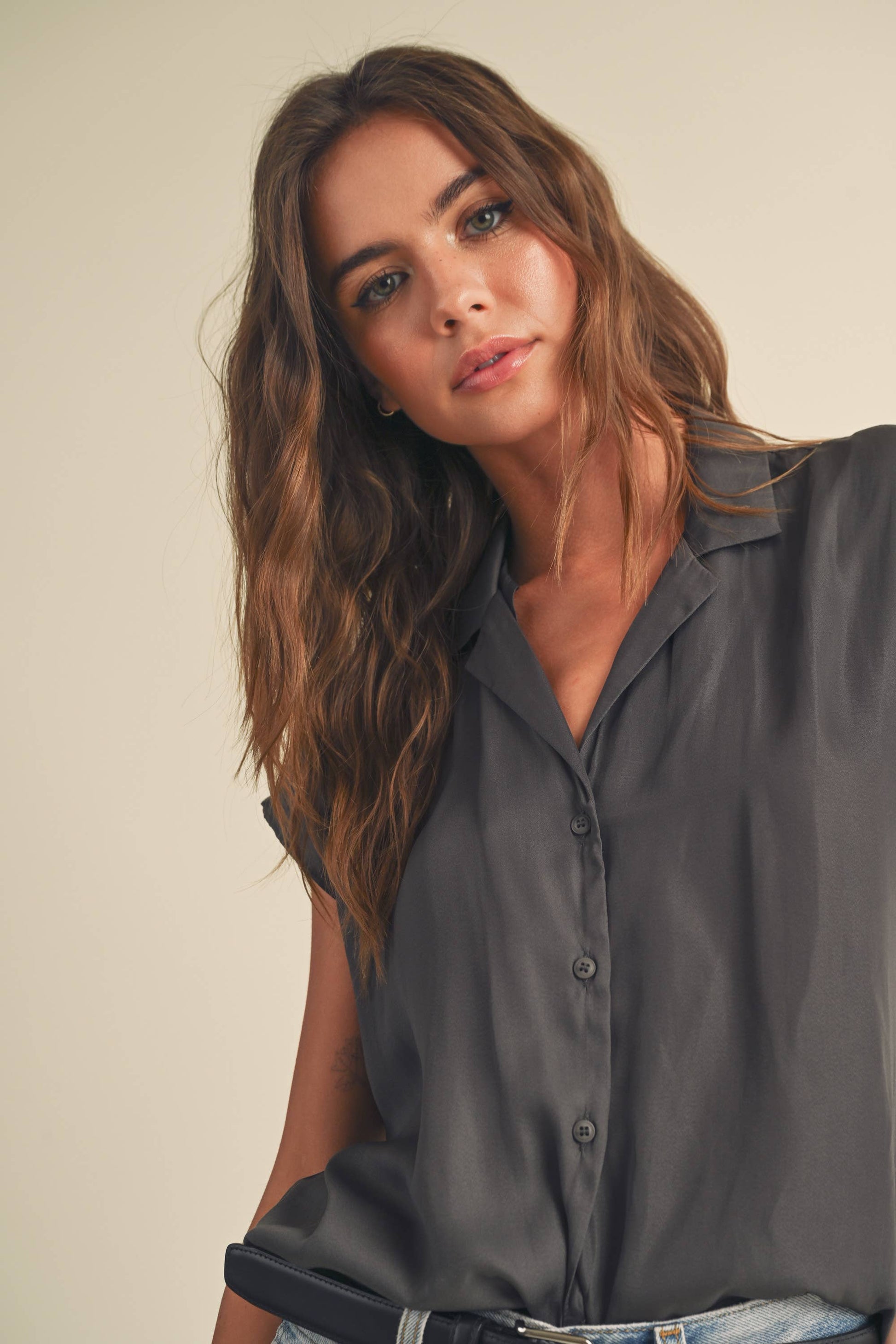 zoomed in view of gray colored Button-down cap sleeve shirt in a light and breathable fabric.