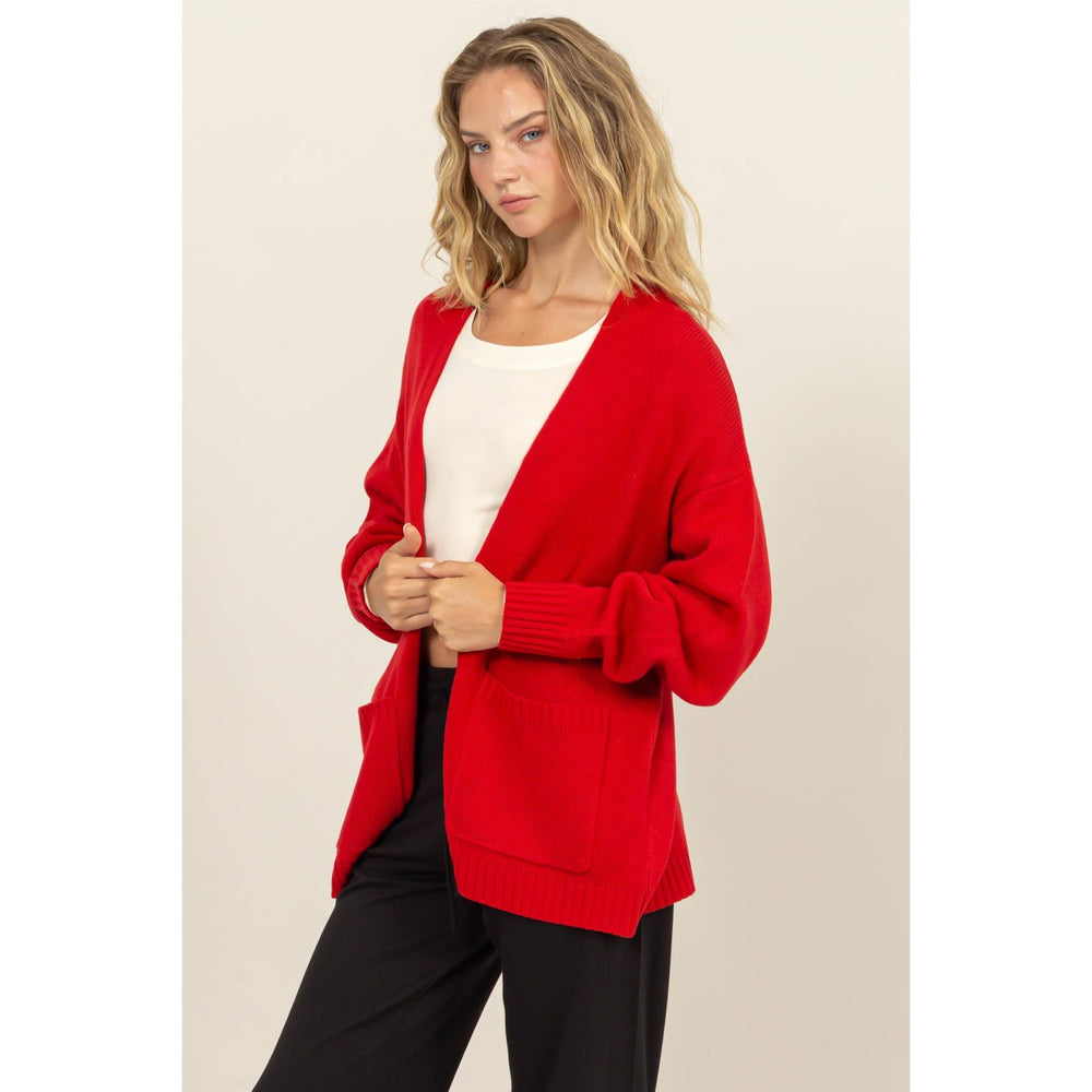 slight side view of Ruby Red Oversized Open-Front Cardigan Sweater with deep front pockets and ribbed cuffs, designed for a relaxed fit, available at Onyx Native.