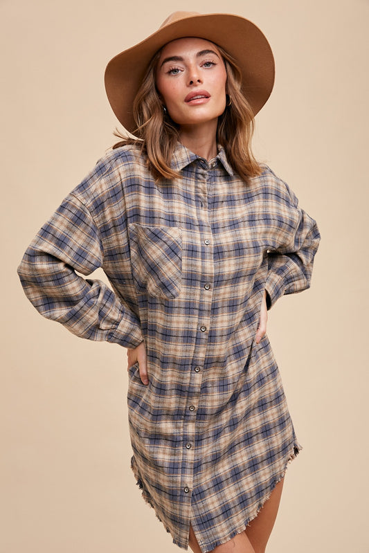 Button-up plaid shirt dress with breast pockets and button closures on cuffs. Made from 60% cotton and 40% polyester. Can be worn as a dress or shacket.