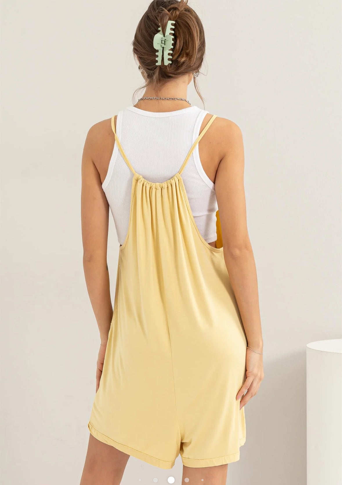 back view of Sunshine Romper in soft jersey with scoop neck, spaghetti shoulder straps, and front patch pockets. Relaxed fit for comfortable wear.