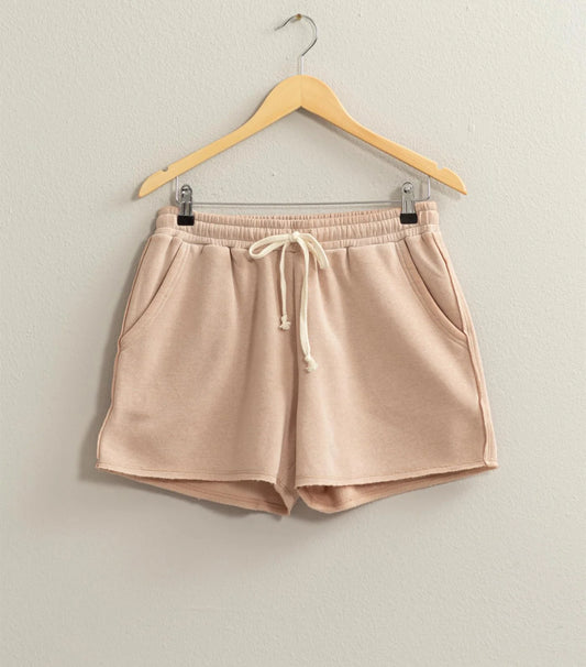 Josie Drawstring Lounge Shorts in soft stretch knit with banded waist, adjustable drawstring, and raw-cut hem. Relaxed fit for comfort. Made from 51% cotton and 49% polyester.