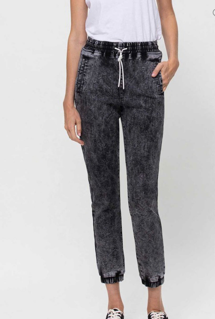 front view of Vervet by Flying Monkey high-waisted jogger pants with drawstring detail, acid wash stretch denim, and relaxed fit. Inseam 25 3/8 inches. Made from 60% cotton, 26% polyester, 11.3% rayon, and 2.7% spandex.