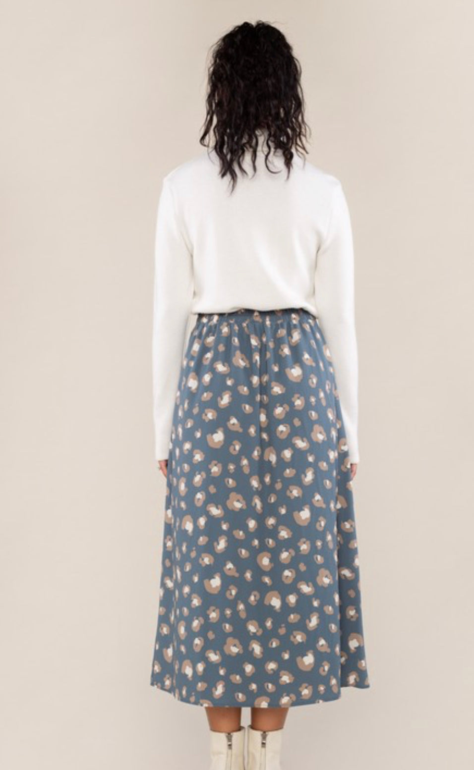 back view of Fully lined A-line skirt with elastic back and side zipper. Made from 100% polyester.