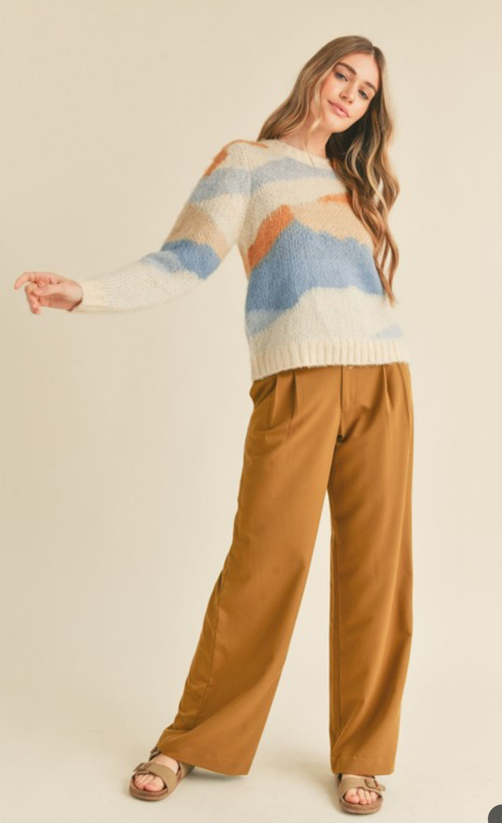 side view of Abstract sweater with a true-to-size fit, ribbed neckline, cuffs, and hem. Loose fit pullover.