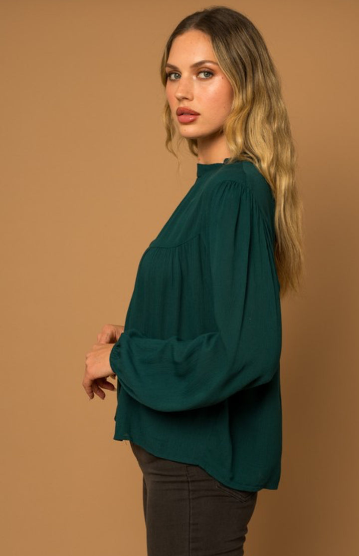slight side view of Women's long sleeve top with mock neck and button back detail, true to size fit, available at Onyx Native.