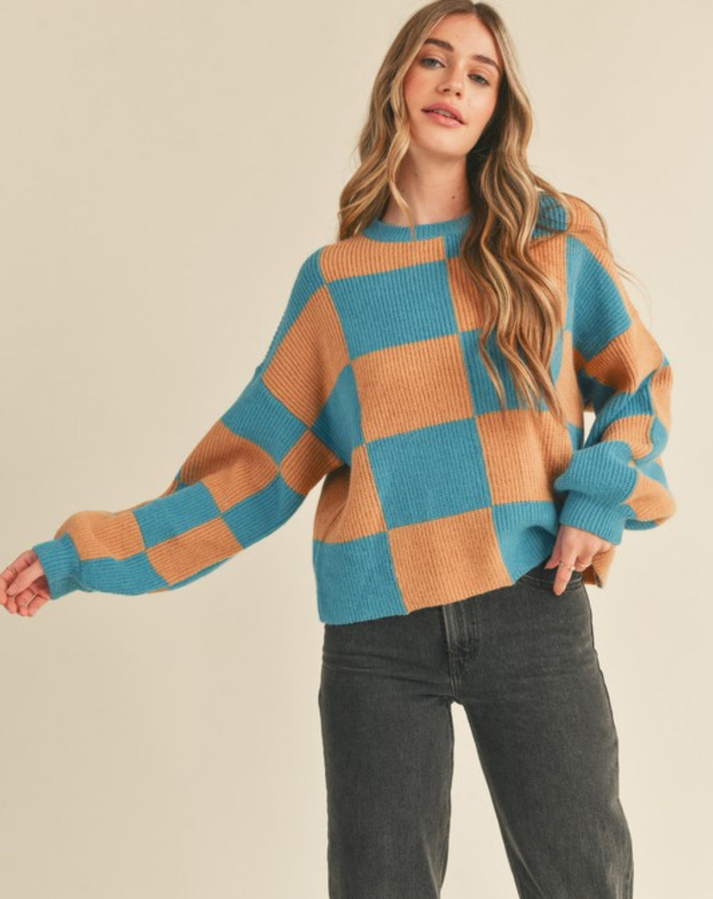 front view of Oversized Check Mate sweater with a crewneck design and ribbed sleeve and neck details. Features a true-to-size fit.