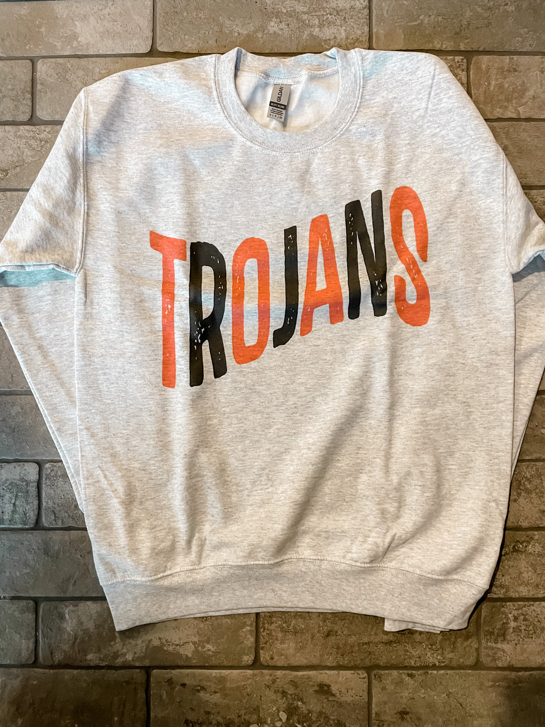 Ash-colored Trojan Crewneck Sweater, DTG printed on a Gildan crewneck sweater. Features a slim, comfortable unisex fit and a 50/50 cotton/poly blend for ultimate comfort and style.