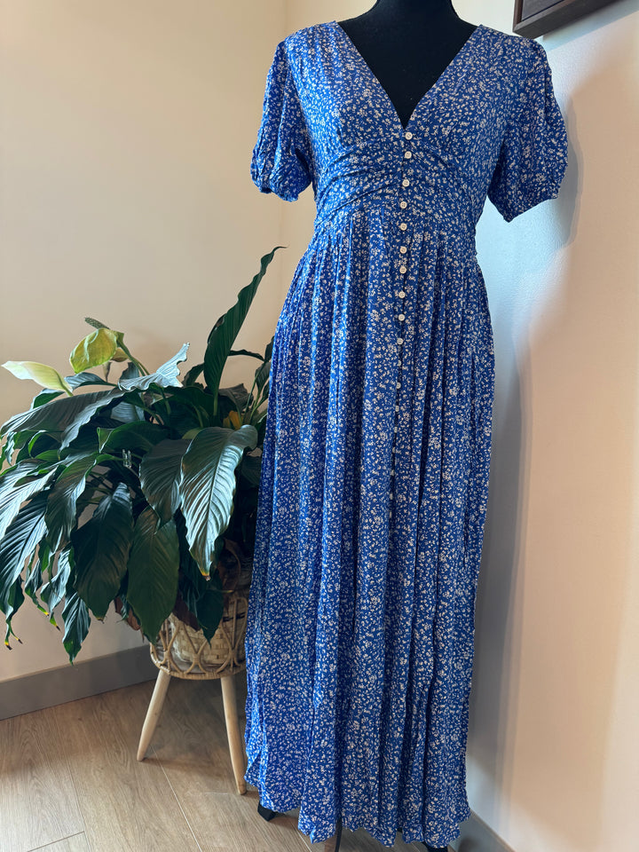 mannequin view of Florence Button Down Maxi Dress with floral print, functional button-down front, ruched waist with smocked elastic back, puff sleeves, and full lining.