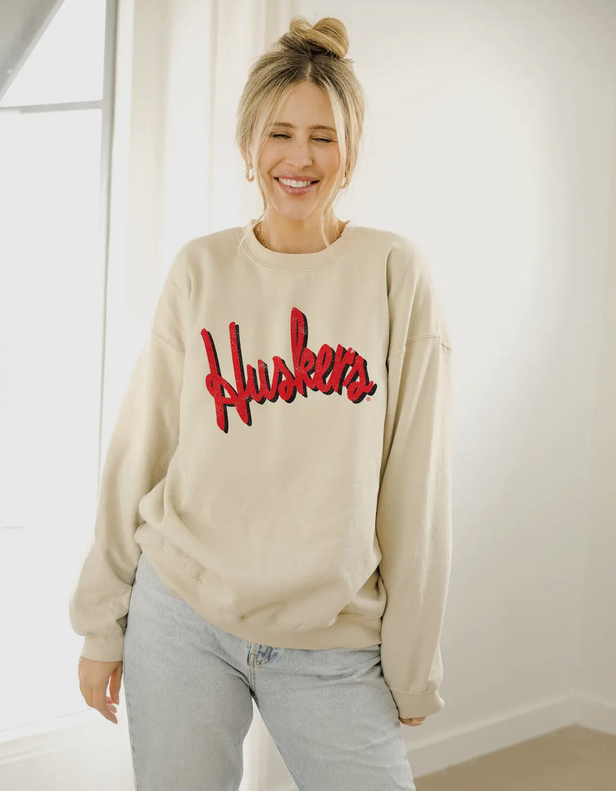 Sand Barbie Nebraska Huskers thrifted sweatshirt with vintage-inspired distressed details and unisex fit.