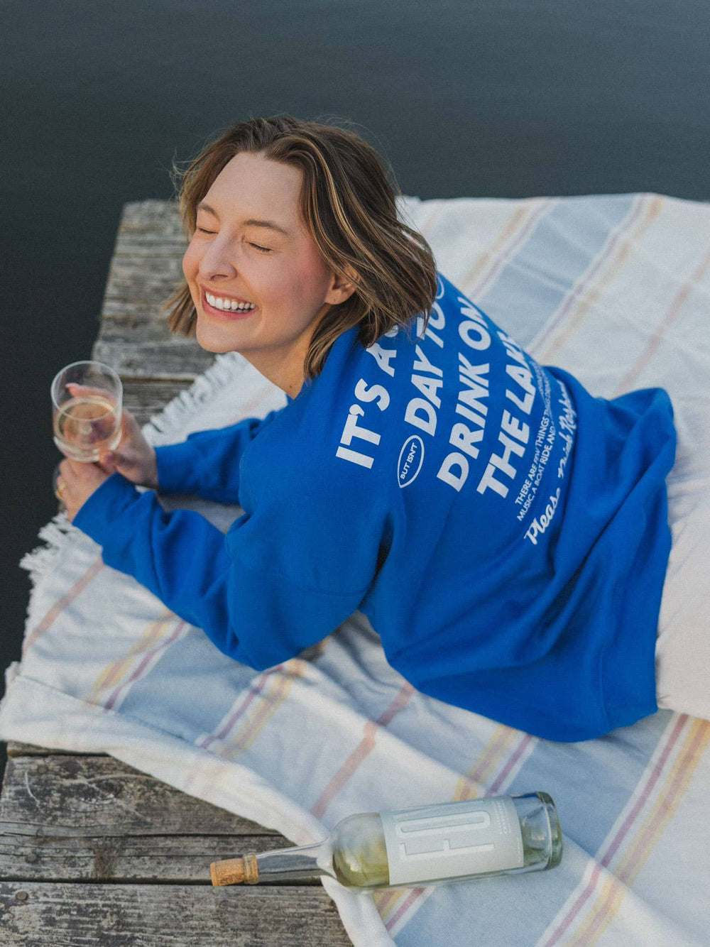 model view of back of Lake Responsibly' Sweatshirt in blue crewneck, perfect for stylish lake days. Ideal gift when paired with a drink sleeve. Emphasizes responsible enjoyment of lake activities.