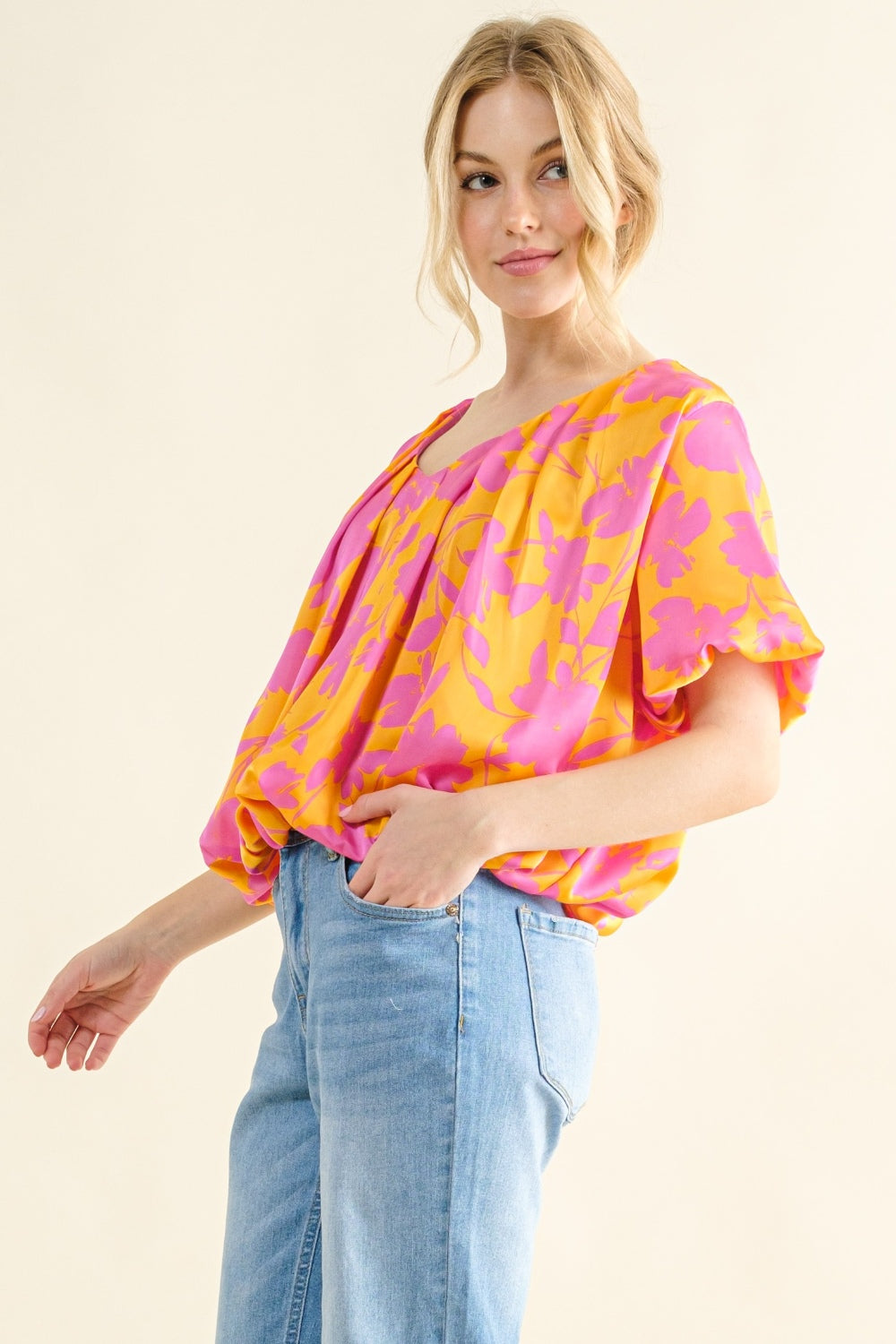 side view of Printed satin bubble hem top with a ruched sheer design and a playful silhouette. Made from 100% polyester, offering a soft, smooth feel. Available in sizes S to 3XL.