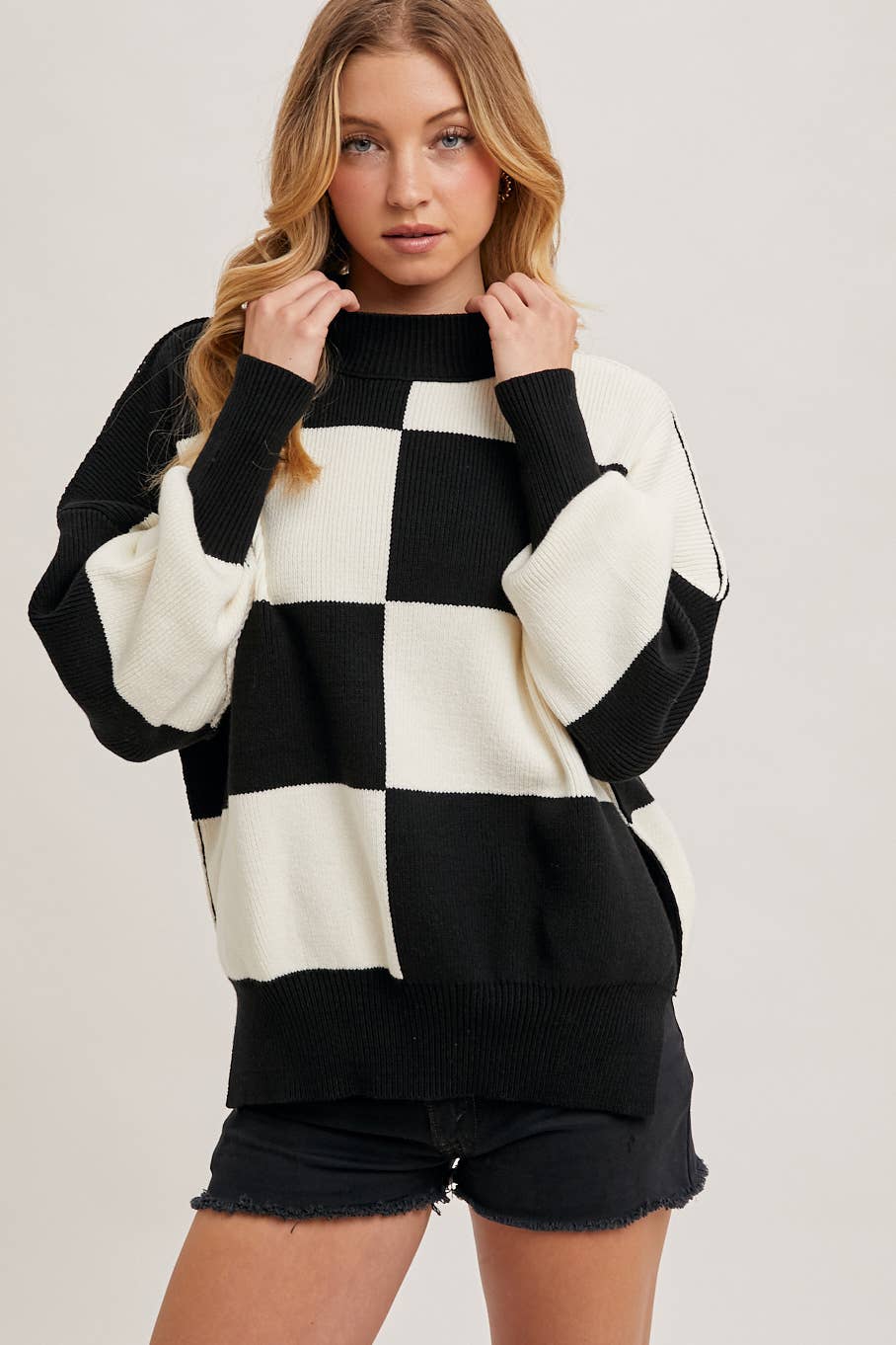 neck detail view of Black Color Block Sweater with dolman sleeves, soft knit fabric, and a stylish design, perfect for versatile styling, available at Onyx Native.