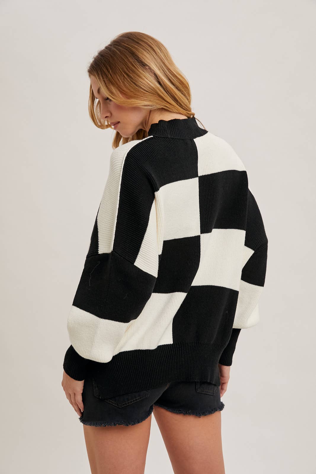 back view of Black Color Block Sweater with dolman sleeves, soft knit fabric, and a stylish design, perfect for versatile styling, available at Onyx Native.