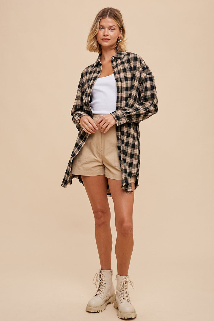 open view of Button-up plaid shirt dress with breast pockets and button closures on cuffs. Made from 60% cotton and 40% polyester. Can be worn as a dress or shacket.
