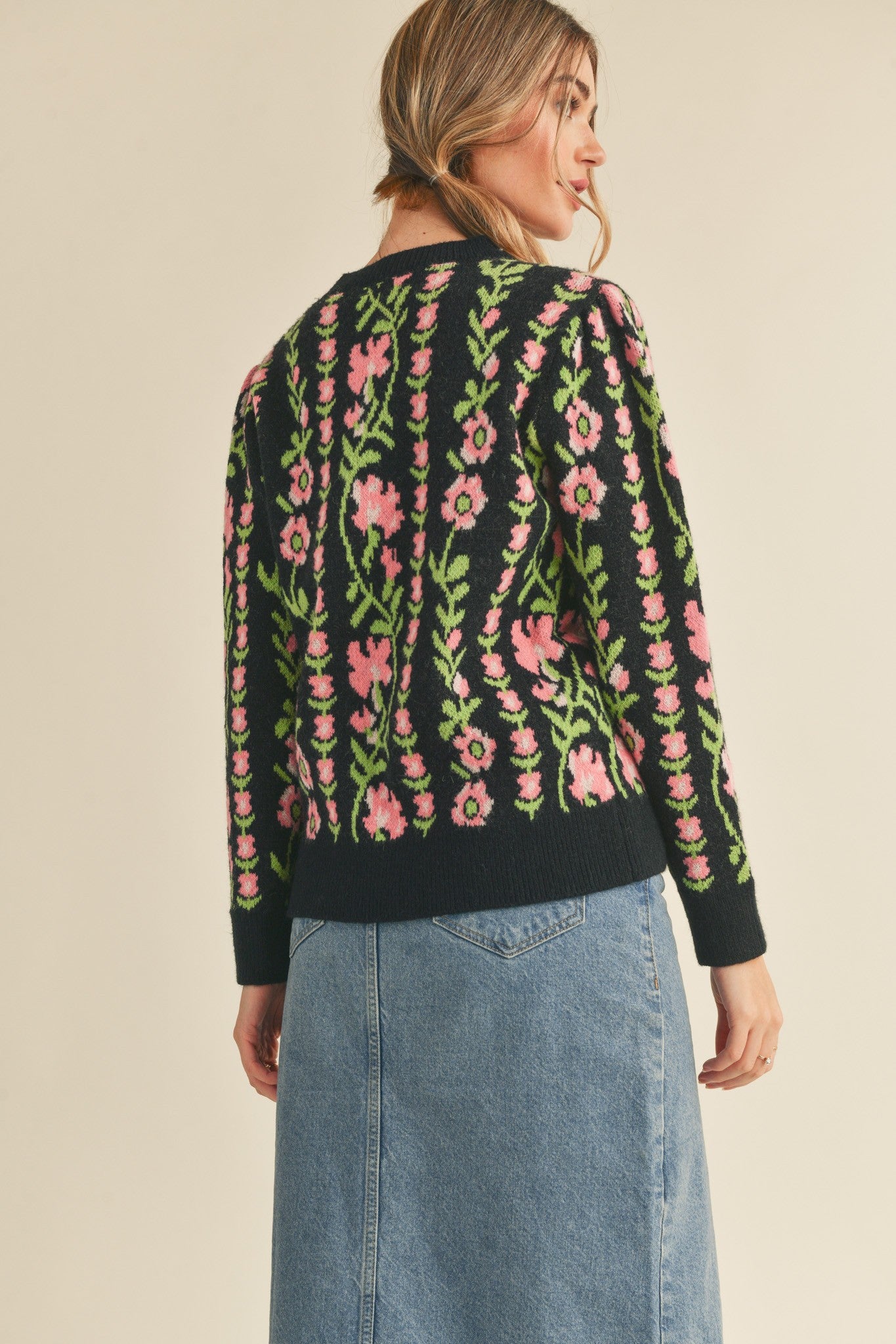 back view of Black Betty Floral Knit sweater with a floral knit pattern. Features a ribbed round neckline, ribbed edges, and a relaxed fit.