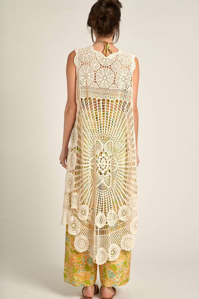 back view of Elevate your style with our Sleeveless High-Low Crochet Cardigan made from 100% cotton. This versatile piece features a high-low design for a chic look.