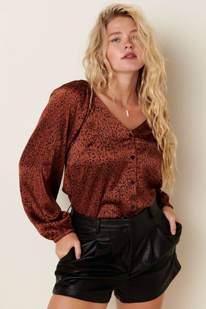 styled view of Satin Leopard Button Down Front V-Neck Woven Blouse with long sleeves, functional placket, and relaxed fit.