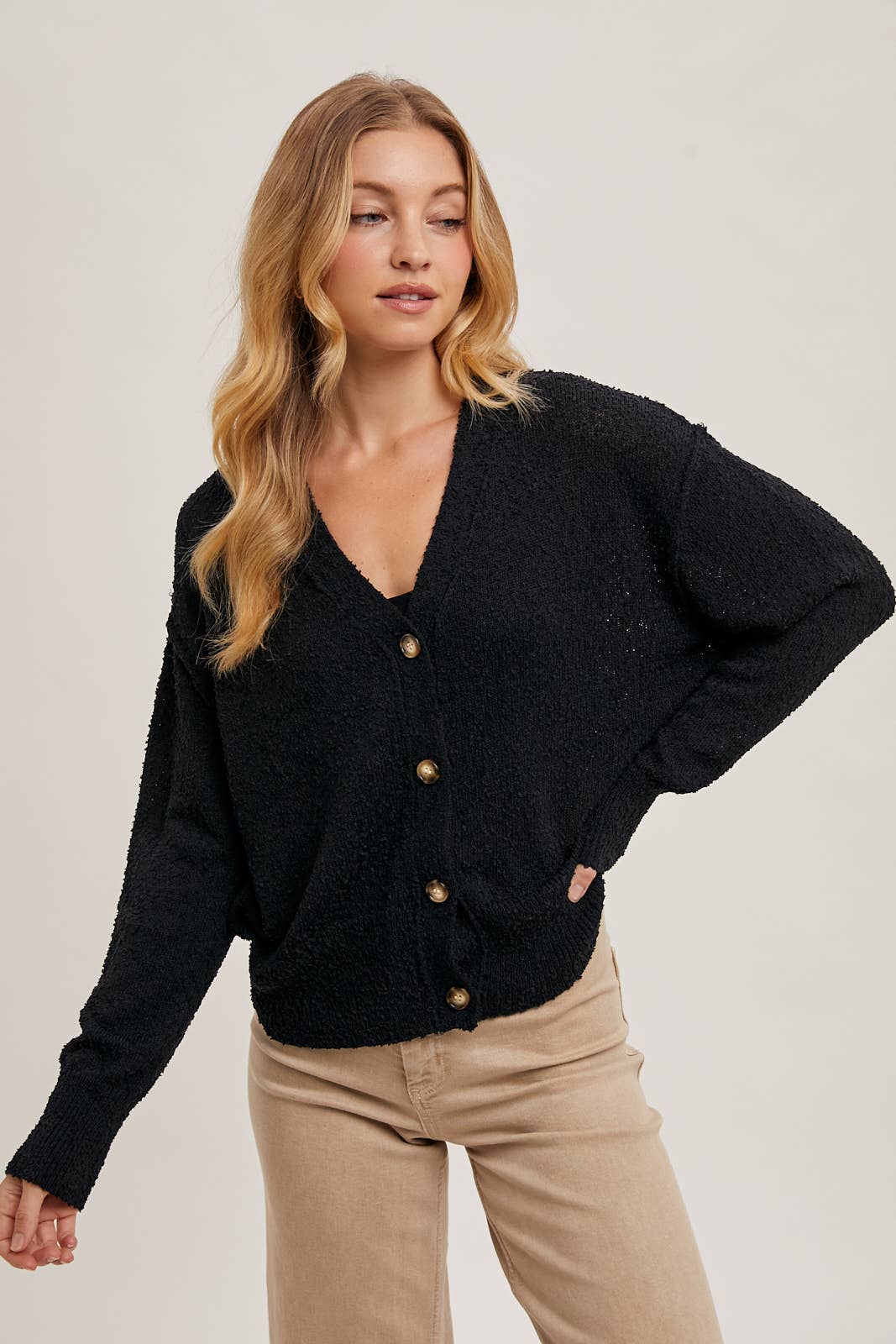 alternate sleeve detail view of Black Betty Button-Down Cardigan with a classic button front, relaxed fit, and long sleeves, made from soft knit fabric for cozy layering, available at Onyx Native.