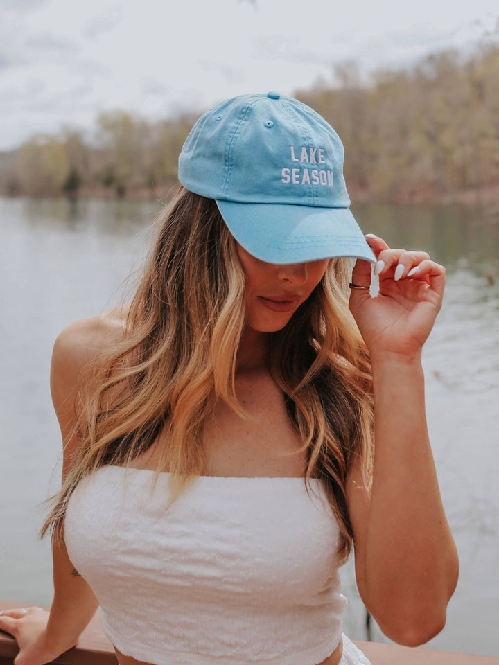 other side view of Lake Season' Hat in aqua with white text, ideal for sunny days at the lake. Perfect for pairing with swimsuits and cover-ups.