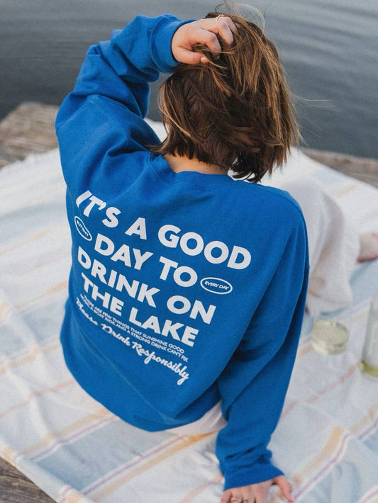 Lake Responsibly' Sweatshirt in blue crewneck, perfect for stylish lake days. Ideal gift when paired with a drink sleeve. Emphasizes responsible enjoyment of lake activities.