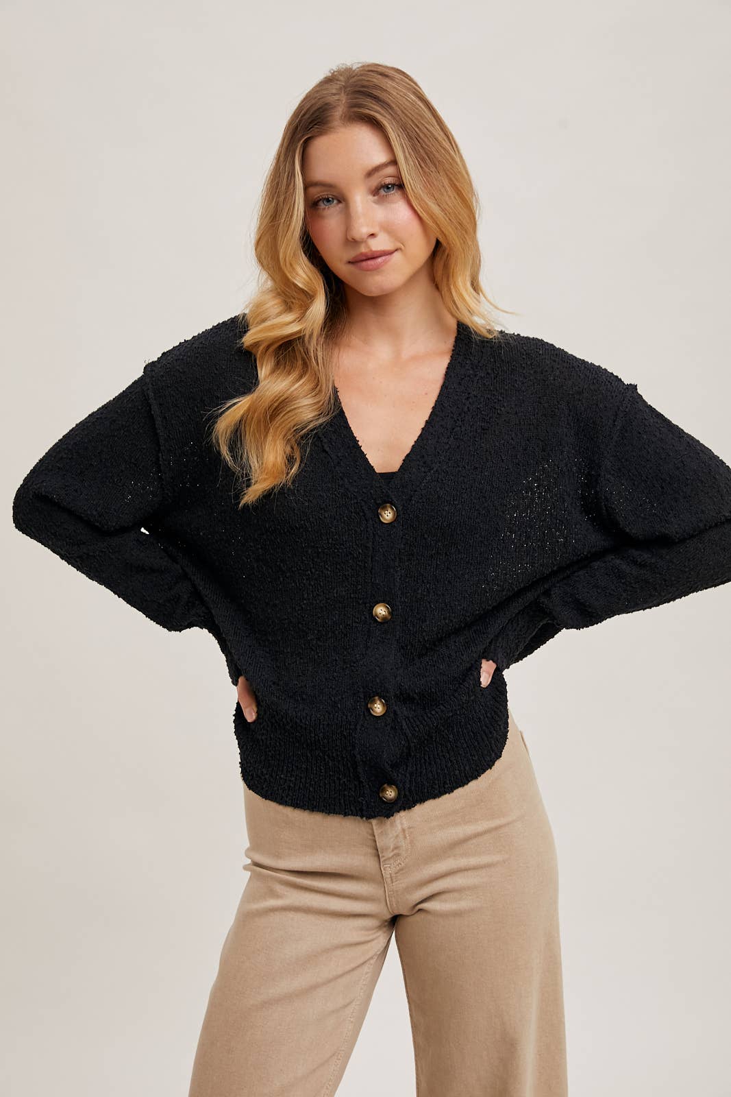 sleeve detail of Black Betty Button-Down Cardigan with a classic button front, relaxed fit, and long sleeves, made from soft knit fabric for cozy layering, available at Onyx Native.