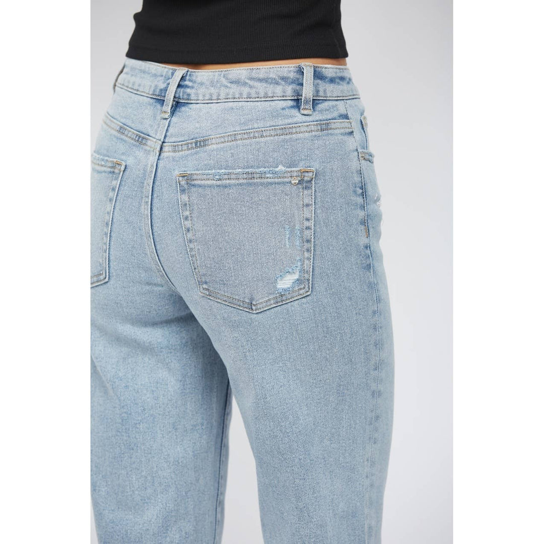 pocket view of High-rise ankle wide-leg jeans in light wash with minimal distressing. Made from 98% cotton and 2% spandex.