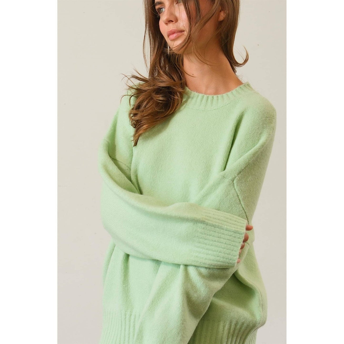 sleeve detail of Jade Oversized Sweater Pullover with dropped shoulders and ribbed crew neckline.