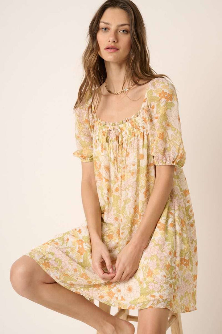 insdie view of Vintage Flower Print Mini Dress with square neck, short puff sleeves, and tie detail on top. Made from chiffon woven fabric and fully lined. Model is 5'9" wearing size Small.