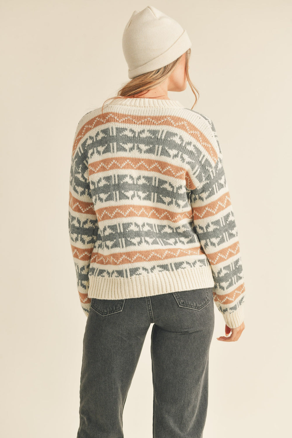 Abstract knit pattern sweater with a ribbed round neck, drop shoulder long sleeves with ribbed cuffs, and an abstract Fair Isle knit design. Features a pullover style and ribbed hem.