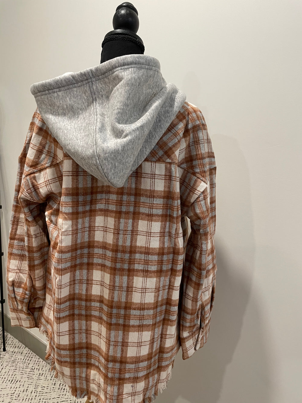 back view of Camel Hooded Plaid Jacket - Frayed hem plaid jacket with a hood, front snap buttons, patch pockets, and a round hem.