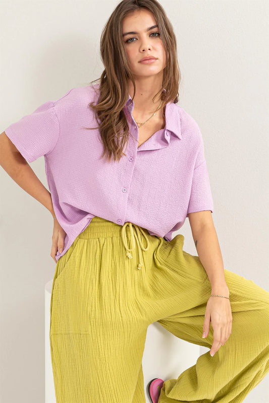 Lavender Haze Button Down Shirt - Textured fabric with point collar, drop shoulders, short sleeves, and a relaxed fit. Tuck-in option for a polished look.