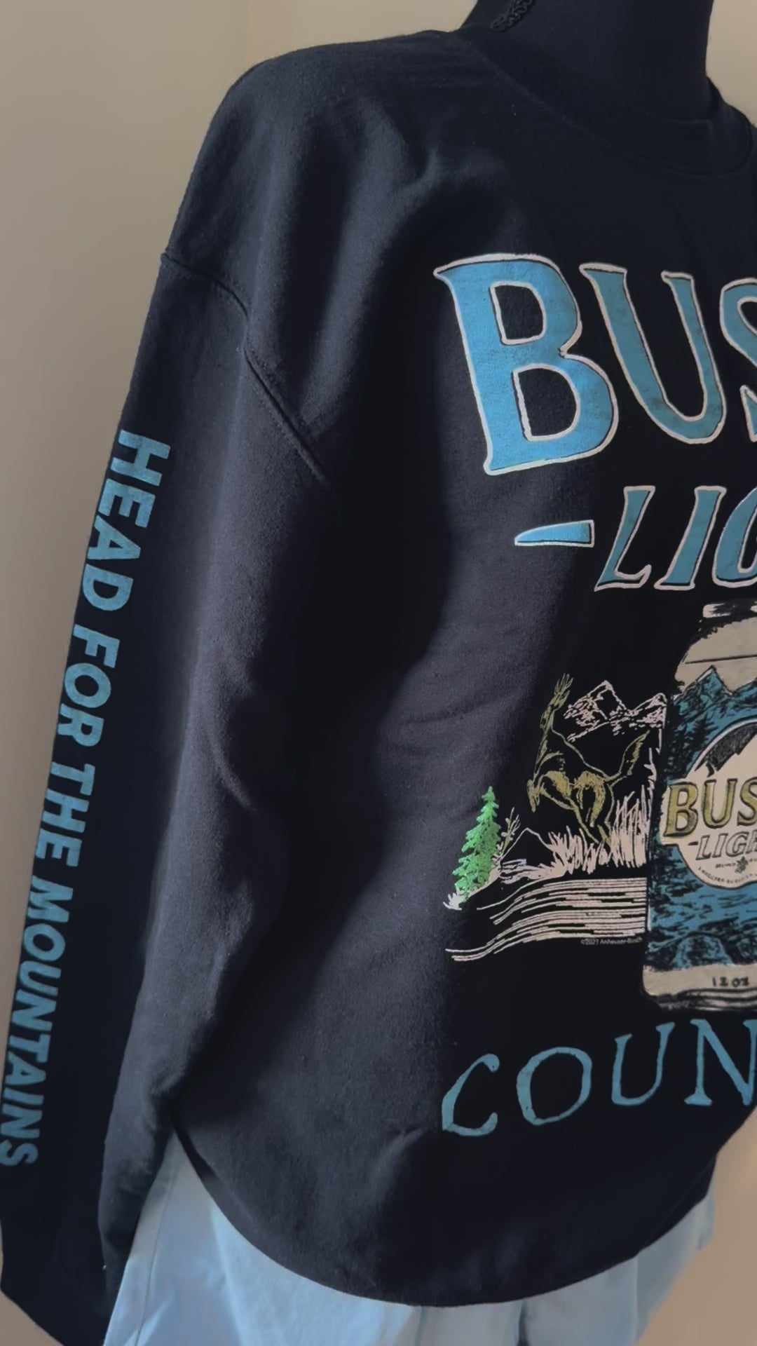 vide of Busch Light Country crewneck sweatshirt with Junkfood design, featuring hunting, fishing, and loving every day slogan. Unisex.