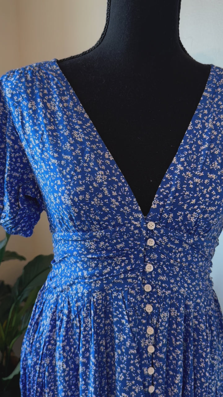 detailed video of Florence Button Down Maxi Dress with floral print, functional button-down front, ruched waist with smocked elastic back, puff sleeves, and full lining.