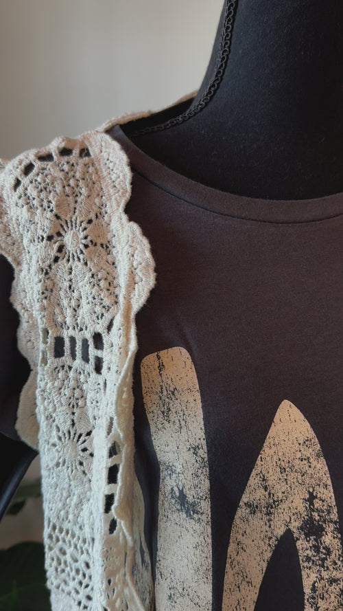 detailed video of Elevate your style with our Sleeveless High-Low Crochet Cardigan made from 100% cotton. This versatile piece features a high-low design for a chic look.