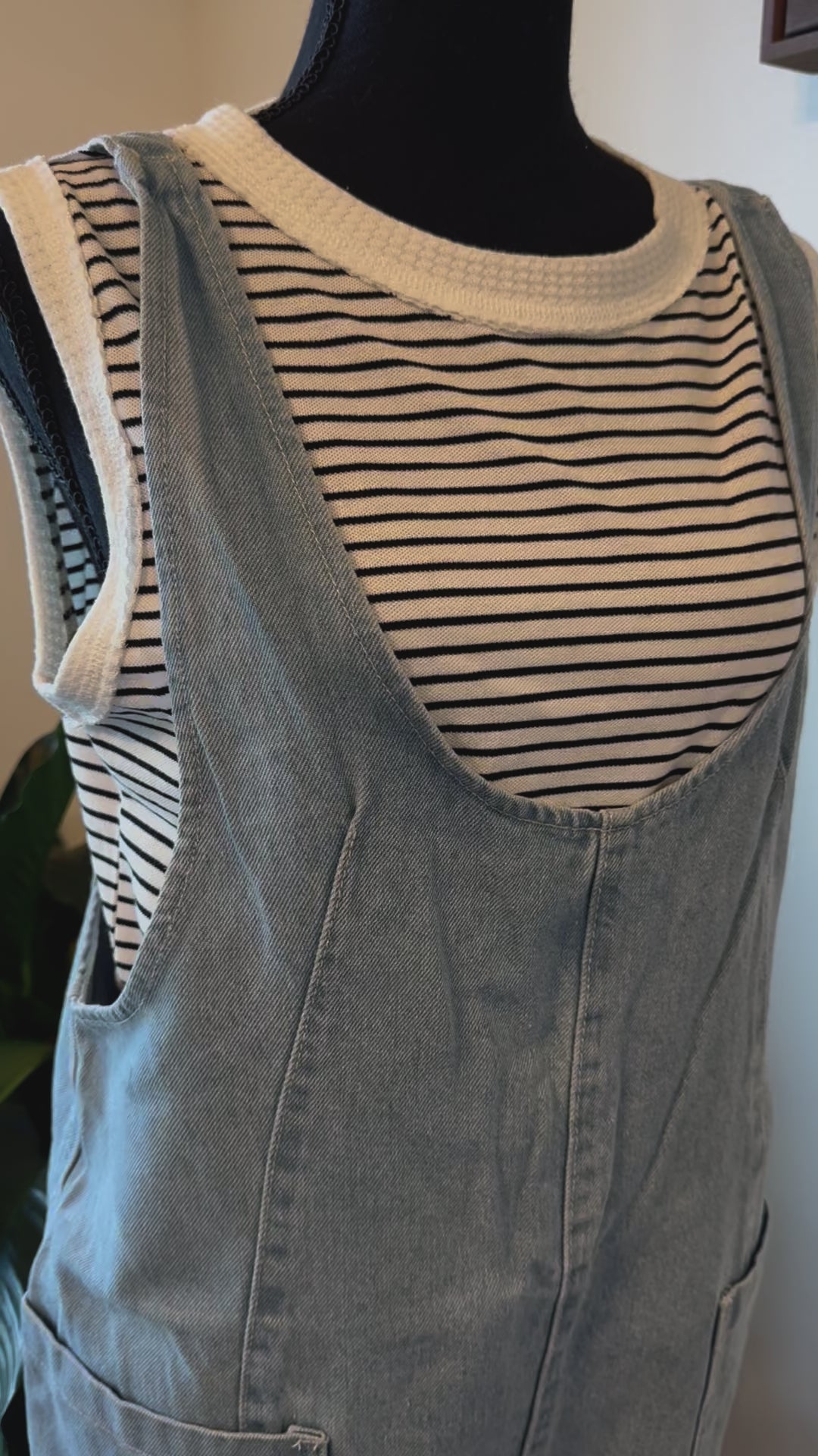 detailed view of Cotton Denim Seam Detail Romper with adjustable straps and front pockets, made of 100% cotton. Available for pre-order with color variations possible due to lighting and monitor differences.