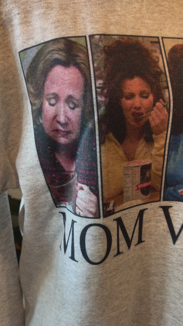 video detail of Mom Vibes Sweatshirt in heather grey, printed on a Gildan crew. Perfect for 90’s kids turned parents, with a recommendation to size up for a looser fit