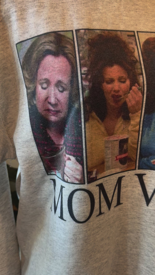 video detail of Mom Vibes Sweatshirt in heather grey, printed on a Gildan crew. Perfect for 90’s kids turned parents, with a recommendation to size up for a looser fit