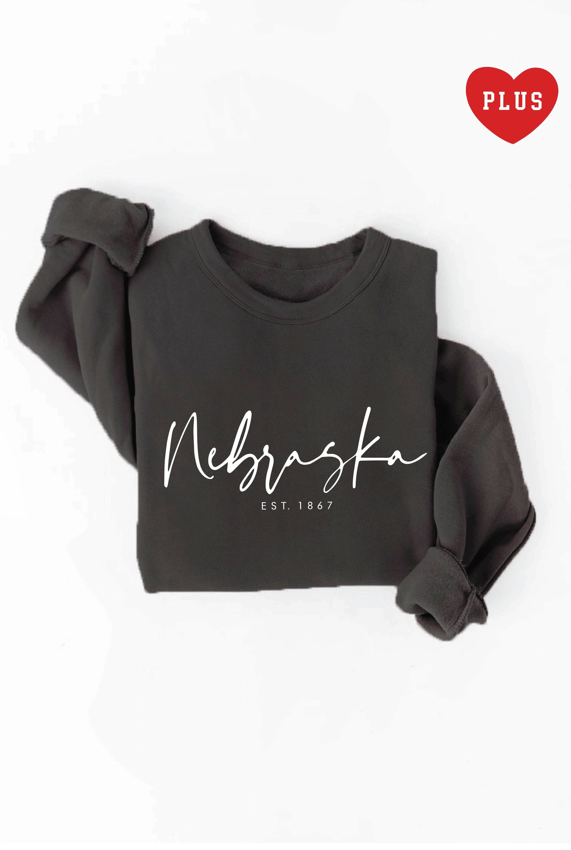 "NEBRASKA EST. 1867" plus graphic sweatshirt in unisex crewneck style. Made from soft fleece with ribbed cuffs and waistband, ideal for daily wear and layering. Refer to size chart for measurements.