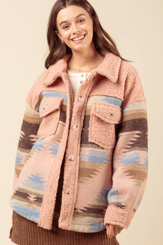 Aztec graphic oversized Sherpa jacket shacket with long sleeves, drop shoulders, patch pockets, and a round hem. Features a button-up front and western blazer design. Model is 5'9" wearing size Small.