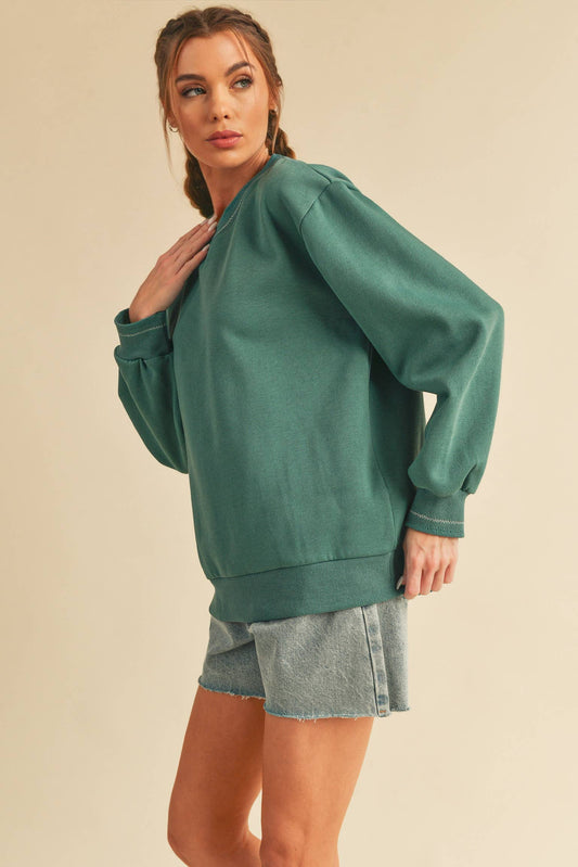 Belicia sweatshirt in Seafoam featuring contrasting embroidery at the neck and cuffs. Made from soft brushed terry fabric for comfort and style.