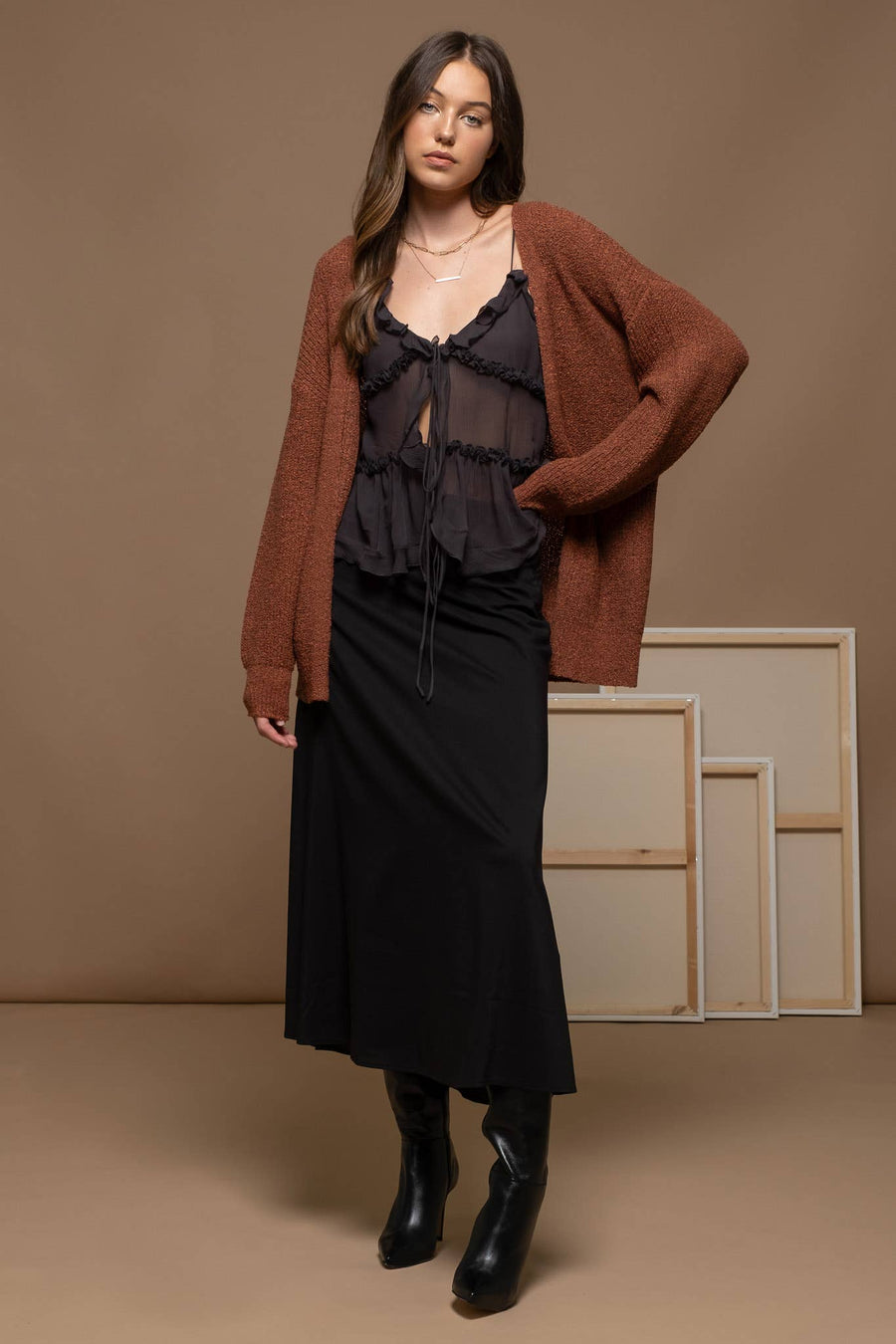 Open front cardigan with long sleeves and a solid design. Features a back criss-cross detail. Made from 74% acrylic and 26% polyester.
